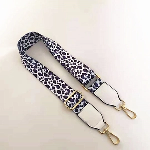 Detail of adjustable bag strap with purple leopard print and gold metal swivel snap hooks
