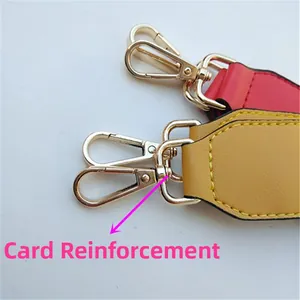 Detail of adjustable bag strap end with gold lobster clasp and fine yellow stitching