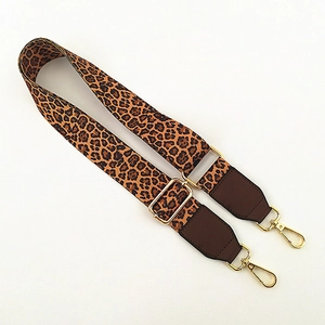 Adjustable wide leopard print bag strap with brown leather ends and gold metal buckles