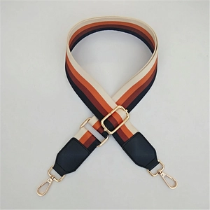 Adjustable retro striped bag strap with brown and orange patterns and gold metal buckles