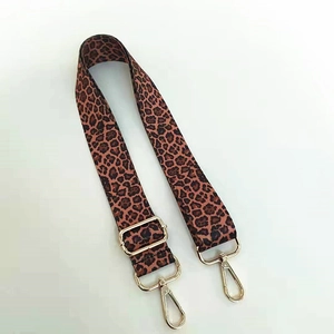 Detail of adjustable leopard print bag strap with polished gold-tone metal hooks