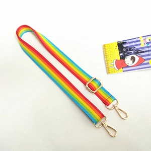 Close-up of rainbow striped adjustable bag strap with shiny gold swivel hooks