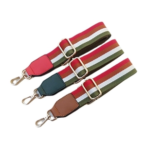Adjustable canvas shoulder straps with striped pattern and gold metal lobster clasps