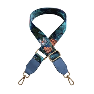 Adjustable floral bag strap with tropical patterns and golden lobster clasps on white base