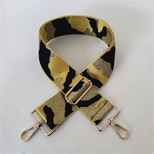 Close-up of leopard pattern bag strap with golden metallic swivel hooks and adjuster