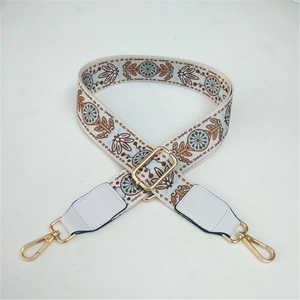 Close-up of Bohemian embroidered bag strap with vintage floral pattern and gold clasps