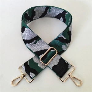 Detail of 5cm wide camouflage bag strap with silver glitter and gold metal hardware