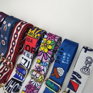 Adjustable woven bag straps featuring colorful floral and geometric patterns with gold buckles