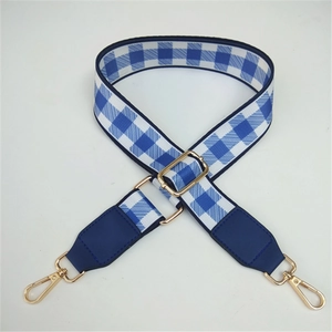 Adjustable blue and white checkered shoulder strap with golden metal hooks for handbags