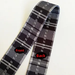 Close-up of adjustable plaid strap showing front and back textures in grey and black