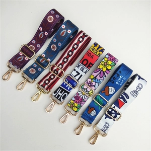 Close-up of adjustable ethnic pattern bag straps with metallic swivel lobster hooks