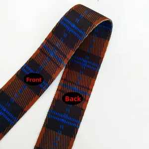 Detail of adjustable British plaid shoulder strap showing front and back fabric texture