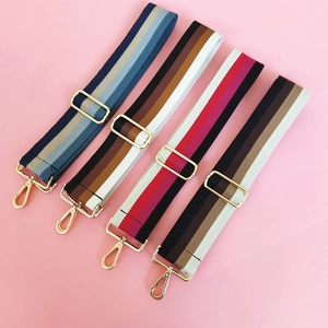 Detail of four colorful striped wide replacement shoulder straps with gold metal hardware