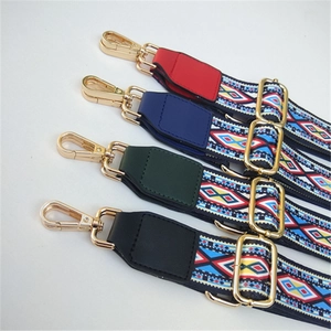 Close-up of ethnic style replacement purse straps with golden metal hooks and hardware