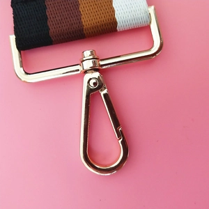 Detail showing high-quality golden lobster clasp and colorful striped woven strap texture