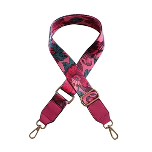 Adjustable floral pattern bag strap with red flowers and golden metal hardware hooks