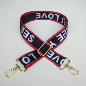 Detail of adjustable nylon strap with LOVE lettering and gold metal swivel hooks