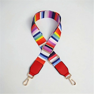 Detail view of rainbow striped adjustable bag strap with gold metal buckle and red leather ends