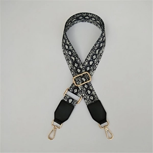 Adjustable snake print bag strap with gold metal hooks and black leather ends