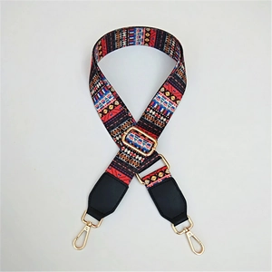 Detail of adjustable bohemian fabric bag strap with golden buckles and ethnic patterns