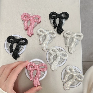 Sparkly rhinestone bow phone socket holder with magnetic attachment and luxury pink design