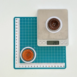 Detail of 5cm wooden phone grip showing high-quality stitching and dual-color finish