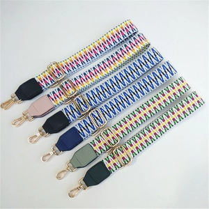 Adjustable woven shoulder straps with colorful geometric patterns and gold metal hooks