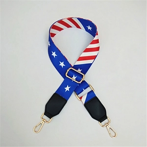 Close-up of adjustable star and stripe woven strap with gold swivel hooks and leather details