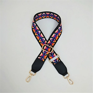 Close-up of geometric pattern strap with golden metal swivel hooks and adjustable buckle