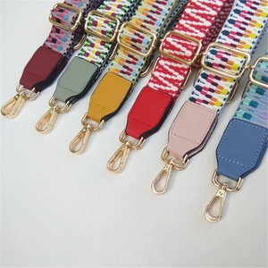 Detailed view of seven colorful bohemian style woven bag straps with gold metal hooks