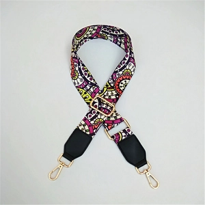 Close-up of bohemian pattern woven bag strap with golden metal swivel hooks and leather ends