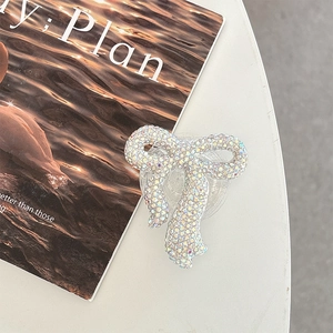 Macro detail of sparkling colorful rhinestone bow phone grip holder on an aesthetic background