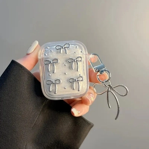 Glitter AirPods case with silver metal bows and a large matching bow pendant