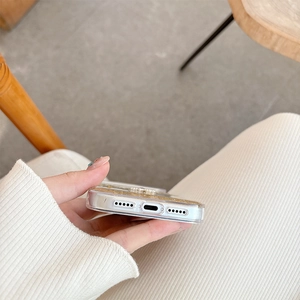 Detail shot of precise speaker and charging port cutouts on a glittery floral iPhone case