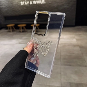 Detail of luxury transparent phone case with a large rhinestone butterfly and silver accents