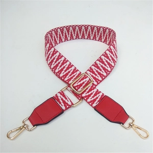 Detail of red and white wave woven bag strap with gold lobster clasps and PU ends