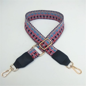 Adjustable woven shoulder strap with black leather ends and gold metal hooks for handbags