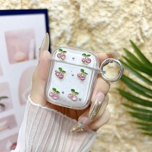 Detailed view of clear glitter AirPods case with pink rhinestone cherry and silver clasp