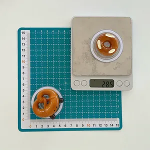 Makroaufnahme der Brezel-Handyhalterung mit Maßen und Gewicht auf einer Digitalwaage