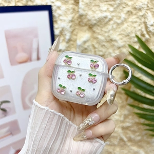 Close-up of pink rhinestone cherry details on glitter earphone case for AirPods