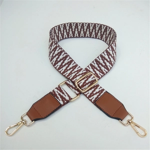 Detail of adjustable woven shoulder strap with brown and white geometric patterns