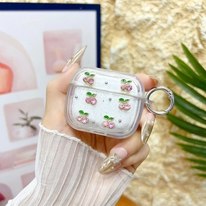 Detail showing glittery cherry rhinestone case for AirPods Pro with silver metal carabiner
