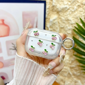 Close-up of clear TPU case for AirPods Pro with sparkly silver cherry and gemstone decor