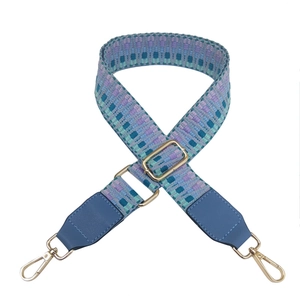 Adjustable colorful woven PU leather bag strap with gold hardware on white background