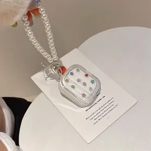 Detailed view of clear AirPods case with colorful stars and a pearl chain handle strap