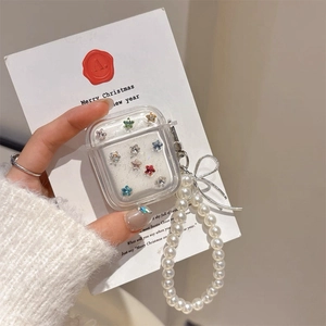 Detail of transparent AirPods case with colorful star rhinestones and pearl chain handle