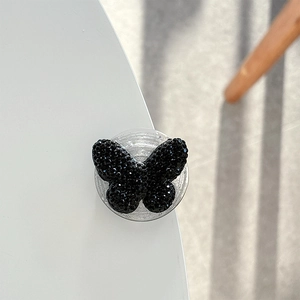 Detailed view of luxury black rhinestone butterfly phone grip with glossy crystal stones