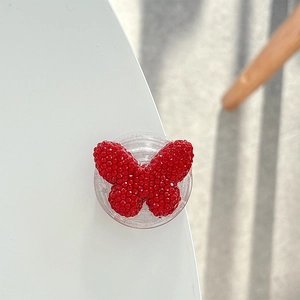 Detail of red butterfly phone grip featuring intricate beadwork and rhinestones
