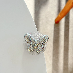 Macro shot of 3D crystal butterfly phone socket with iridescent rhinestones and clear base