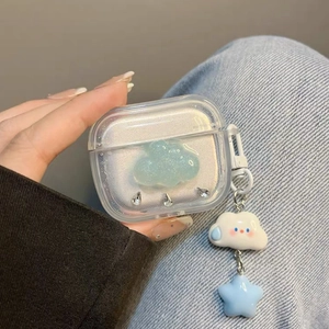 Clear AirPods 4 case with 3D blue cloud, rhinestones, and star pendant held in hand